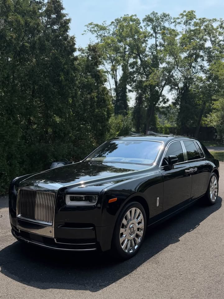 Black luxury sedan with a deep, reflective exterior finish after detailing
